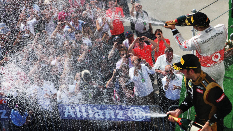 Romain Grosjean spraying champagne on the podium at the 2012 Hungarian Grand Prix