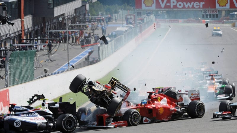 Romain Grosjean's Lotus is thrown into the air after a collision at the start of the 2012 Belgian Grand Prix at Spa