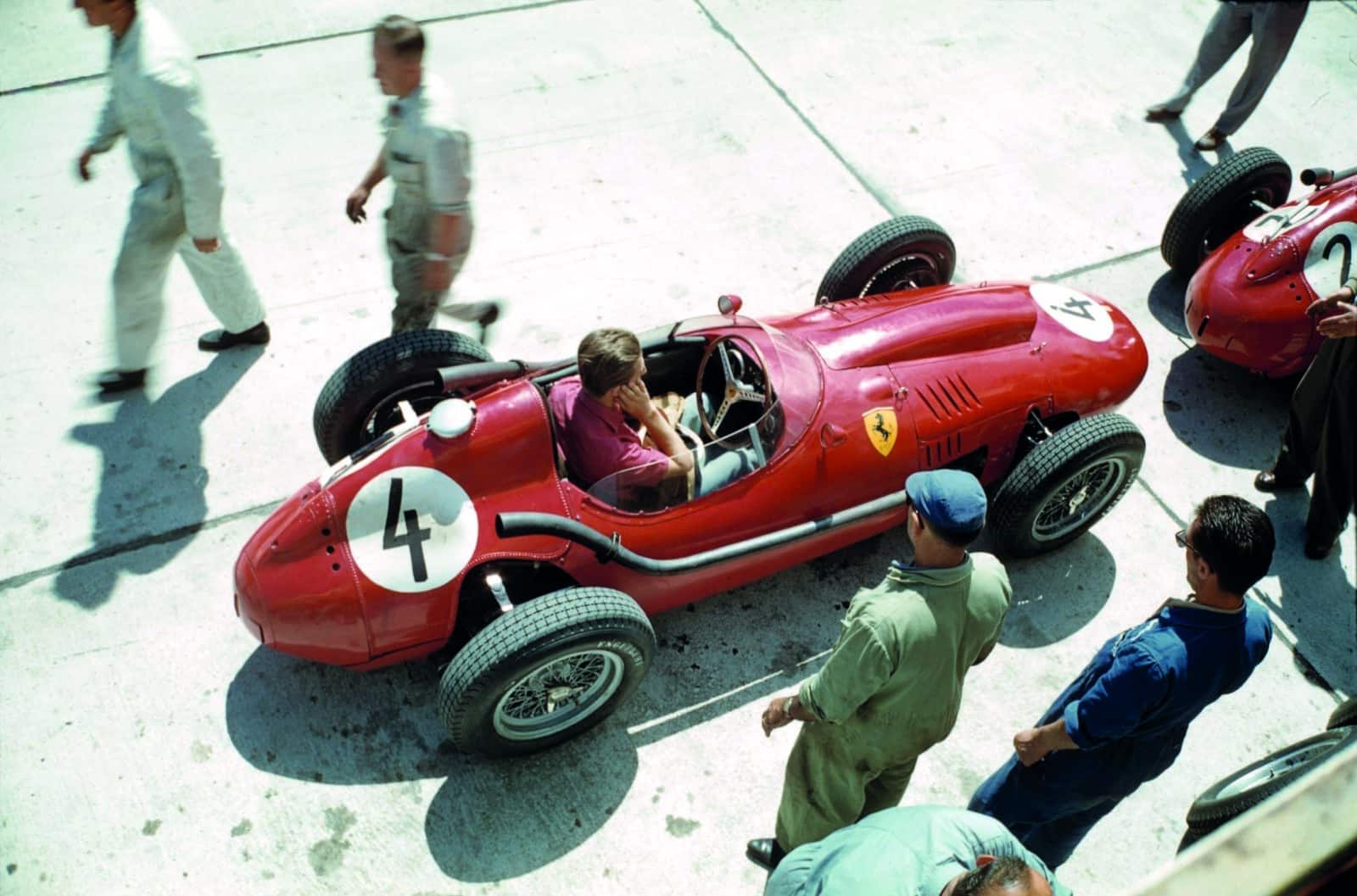 Wolfgang-von-Trips-covers-his-ears-while-sitting-in-his-Ferrari-Dino-246-behind-Peter-Collins-car-at-the-1958-German-Grand-Prix-at-the-Nurburgring