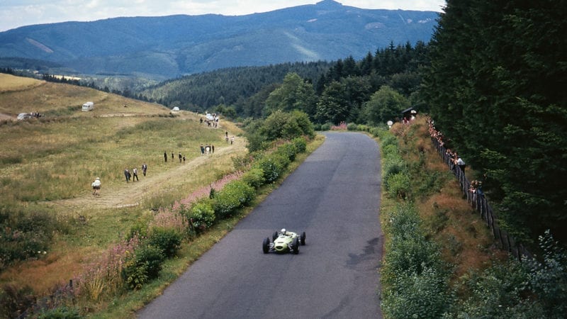 Jim Hall is but a tiny dot on the Eifel landscape as he races his Lotus-BRM 24 at the Nürburgring in 1963