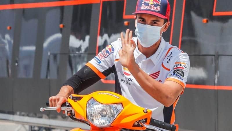 Marc Marquez holds his hand up