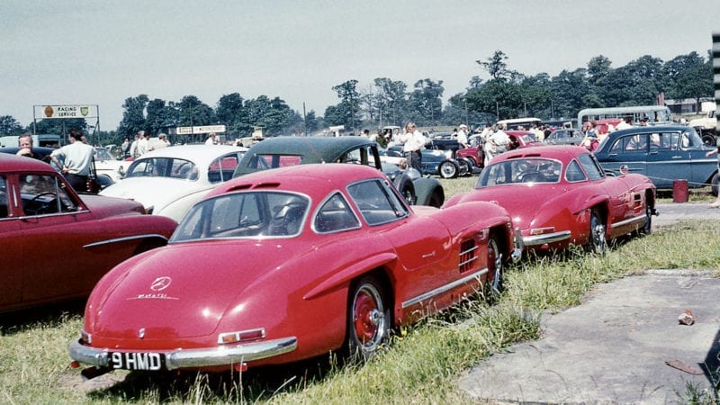 Not your average carpark: a pair of red Mercedes-Benz 300 SL Gullwings sit outside Oulton Park