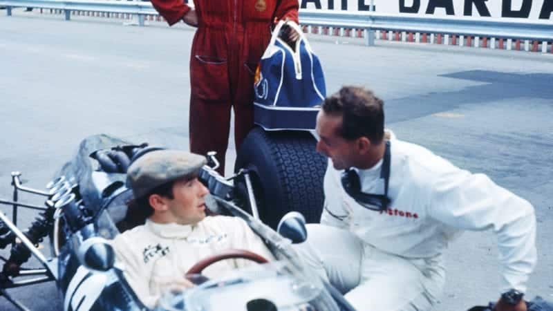 Phil Hill talks to Jackie Stewart in his BRM at Monaco in 1966