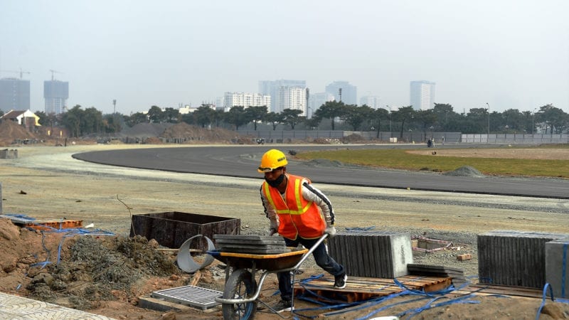 A worker with a wheelbarrow at the Hanoi Street Circuit in Vietnam
