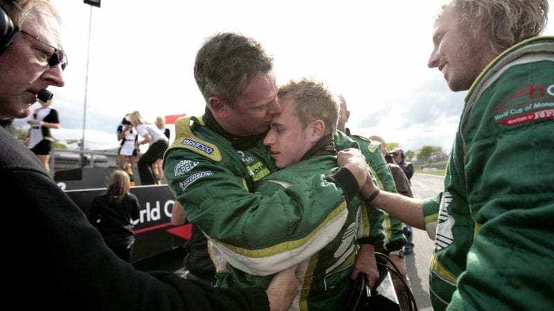 Ireland's A1GP racing driver Adam Carroll (2-R) celebrates with his chief mechanic after winning the A1GP world cup at Brands Hatch circuit on May 3, 2009. AFP PHOTO/Shaun Curry (Photo credit should read SHAUN CURRY/AFP via Getty Images)