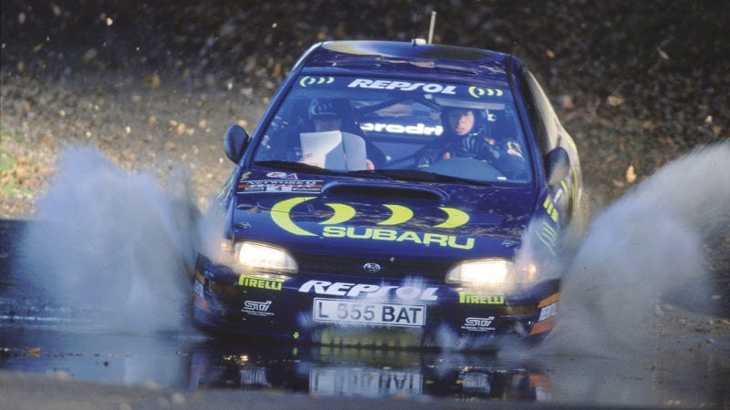 Subaru of Colin McRae splashes through water on the 1995 RAC Rally