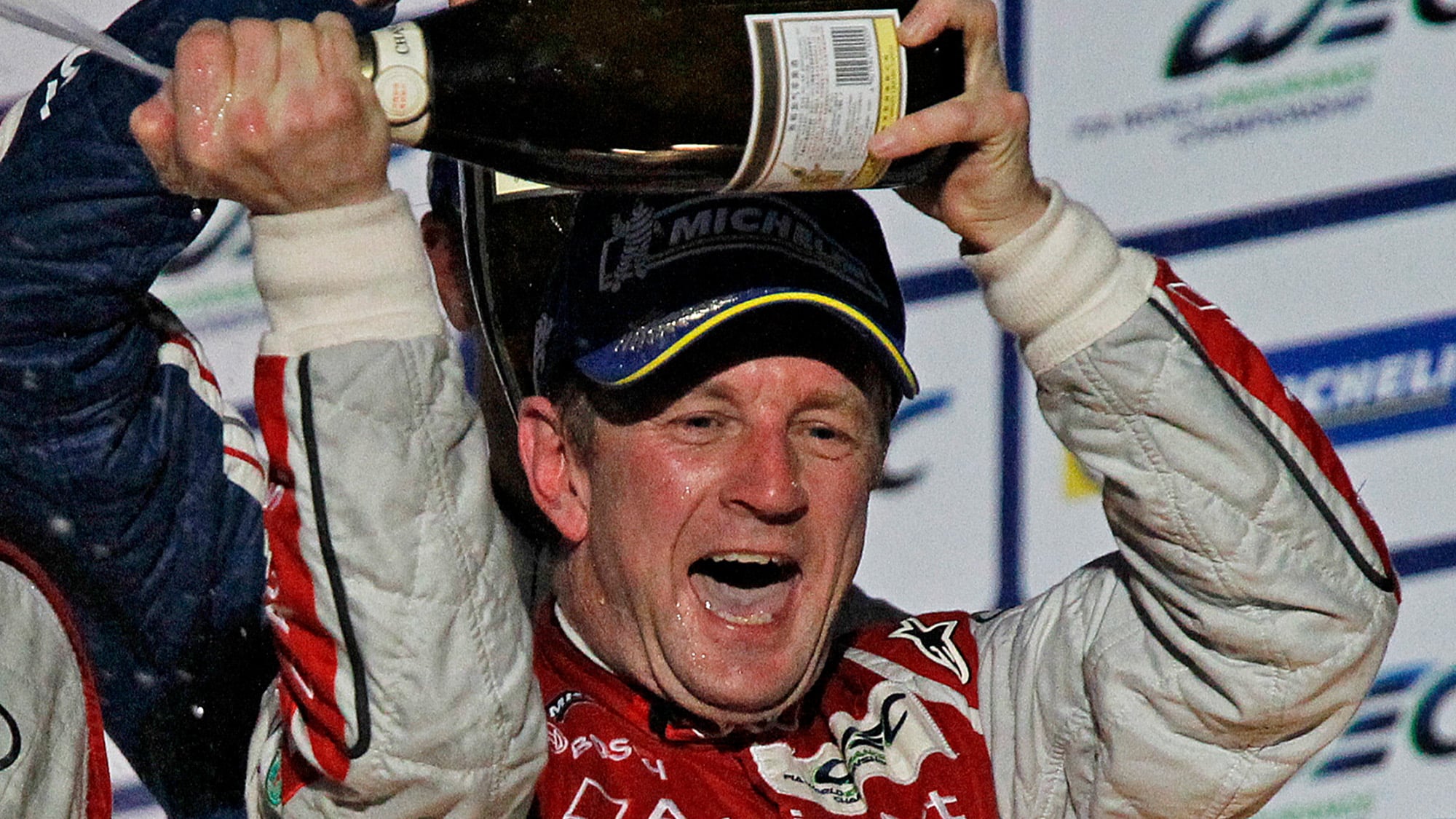 Allan McNish celebrates victory on the podium