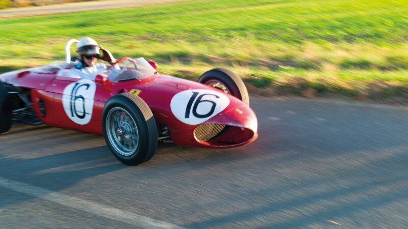 Blurred shot of Derek Hill driving Sharknose Ferrari