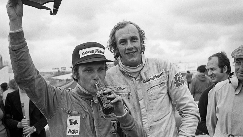 Niki Lauda, Hans-Joachim Stuck, Ferrari 312B3-74, March-Ford 741, Grand Prix of Spain, Circuito del Jarama, 28 April 1974. Niki Lauda celebrating his first Formula One Grand Prix victory for Ferrari in the 1974 Spanish Grand Prix, here with Hans-Joachim Stuck who finished fourth. (Photo by Paul-Henri Cahier/Getty Images)