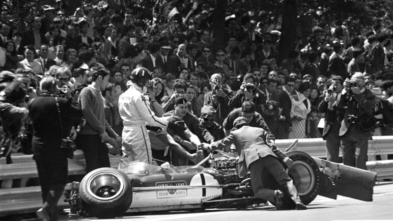 Graham Hill and his crashed Lotus at Montjuich Park in 1969