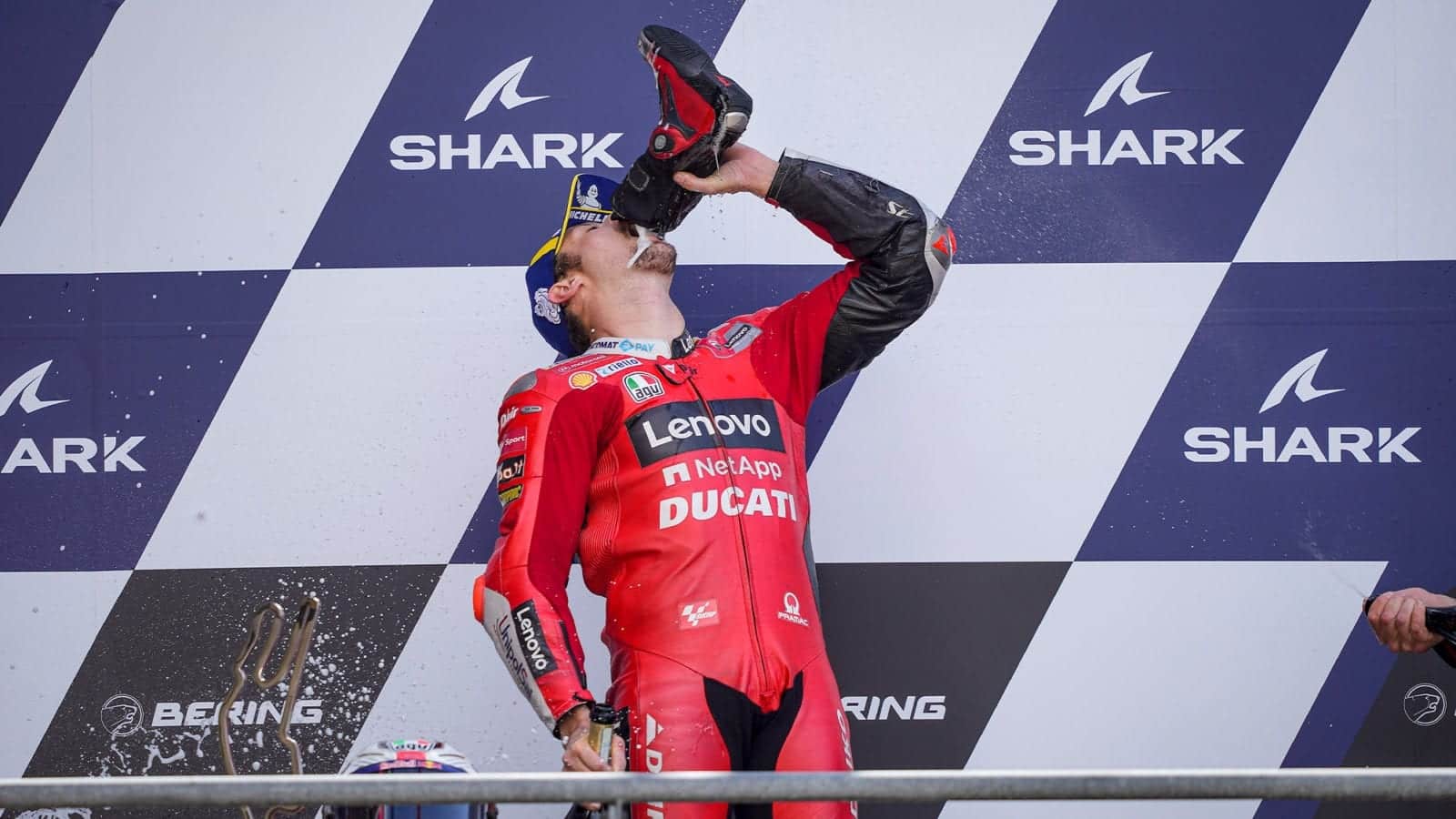 Jack Miller drinks champagne from his shoe at the 2021 MotoGP French GP