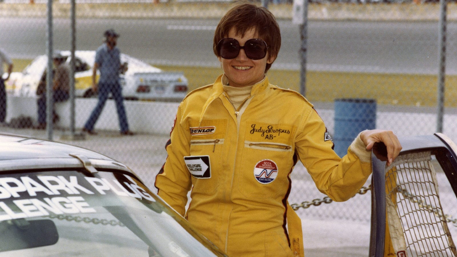 DAYTONA BEACH, FL - 1979: Judy Stropus poses with her Champion Spark Plug Challenge car at Daytona International Speedway. Stropus was considered a top professional at race timing and scoring and worked with many teams including Roger Penske Racing. She also became involved in motorsports public relations. (Photo by ISC Images & Archives via Getty Images)