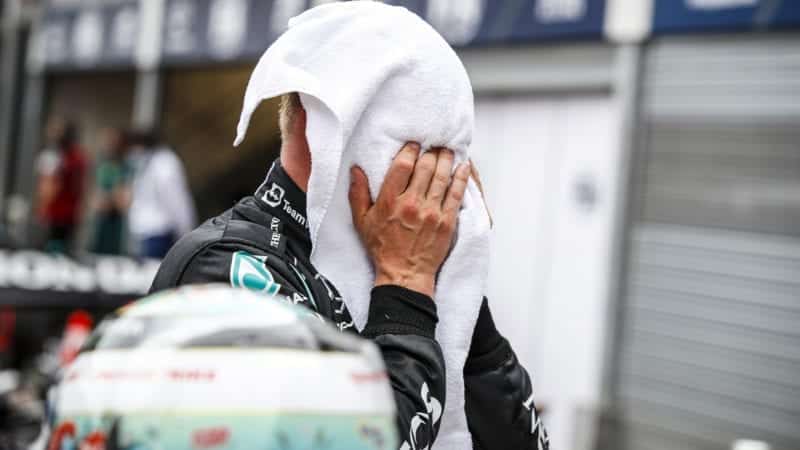 Valtteri Bottas with his face in a towel after 2021 Monaco GP qualifying
