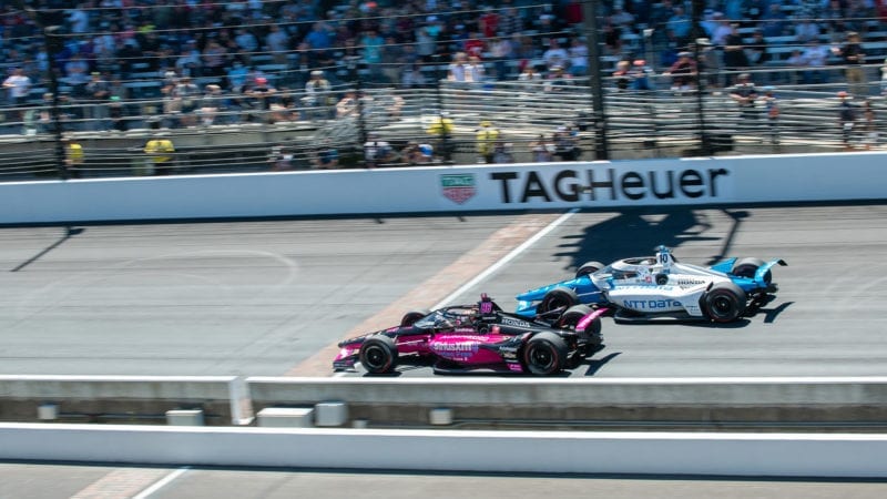 Helio Castroneves fights with Alex Palou in the 2021 indy 500