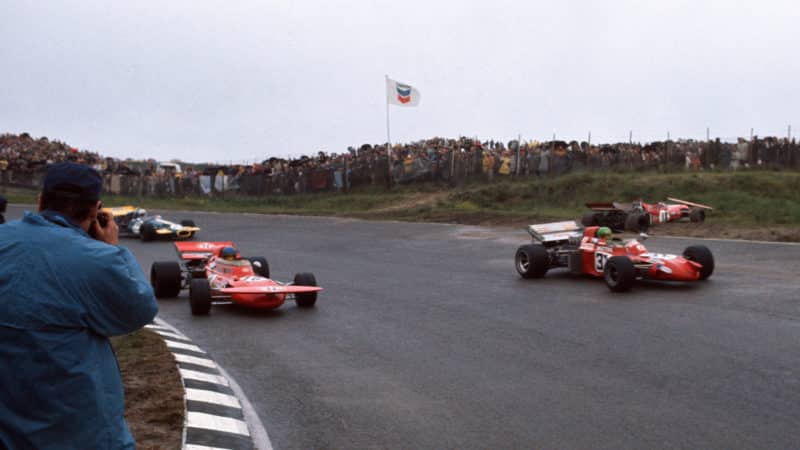 Pescarolo, Peterson and Schenken pass the crashed car of Nanni Galli at the 1971 Dutch GP