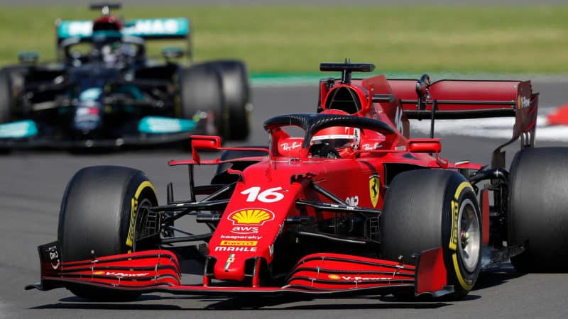 Mercedes' British driver Lewis Hamilton (L) and Ferrari's Monegasque driver Charles Leclerc (R) drive during the Formula One British Grand Prix motor race at Silverstone motor racing circuit in Silverstone, central England on July 18, 2021. (Photo by Adrian DENNIS / AFP) (Photo by ADRIAN DENNIS/AFP via Getty Images)