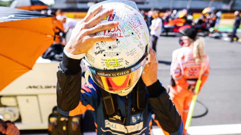 Lando Norris with his 2021 British Grand Prix helmet thanking keyworkers