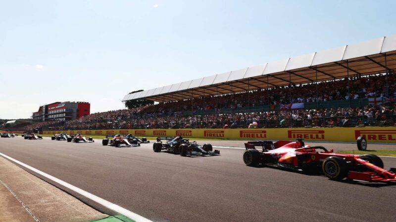 NORTHAMPTON, ENGLAND - JULY 18: Charles Leclerc of Monaco driving the (16) Scuderia Ferrari SF21 leads Lewis Hamilton of Great Britain driving the (44) Mercedes AMG Petronas F1 Team Mercedes W12 at the restart during the F1 Grand Prix of Great Britain at Silverstone on July 18, 2021 in Northampton, England. (Photo by Mark Thompson/Getty Images)