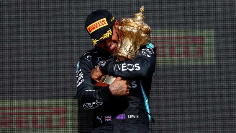 Lewis Hamilton holds the trophy after he wins the 2021 British Grand Prix