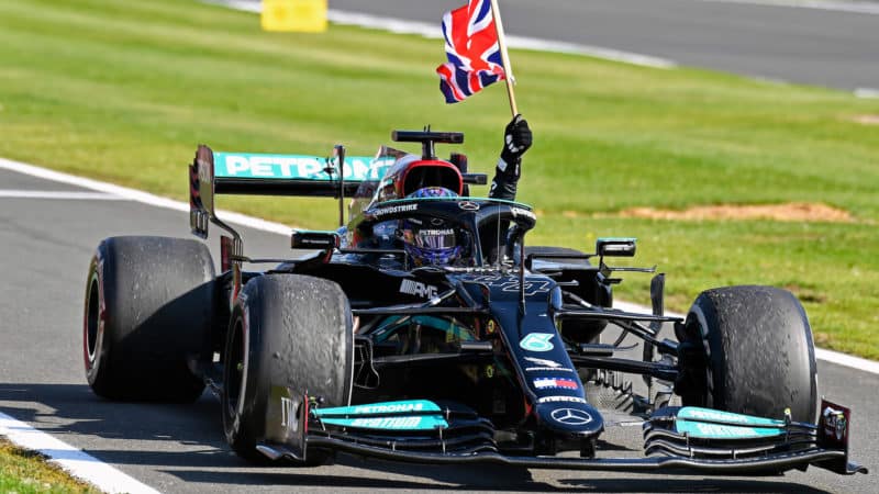 Lewis Hamilton waves the Union Jack from his car after winning the 2021 British Grand Prix