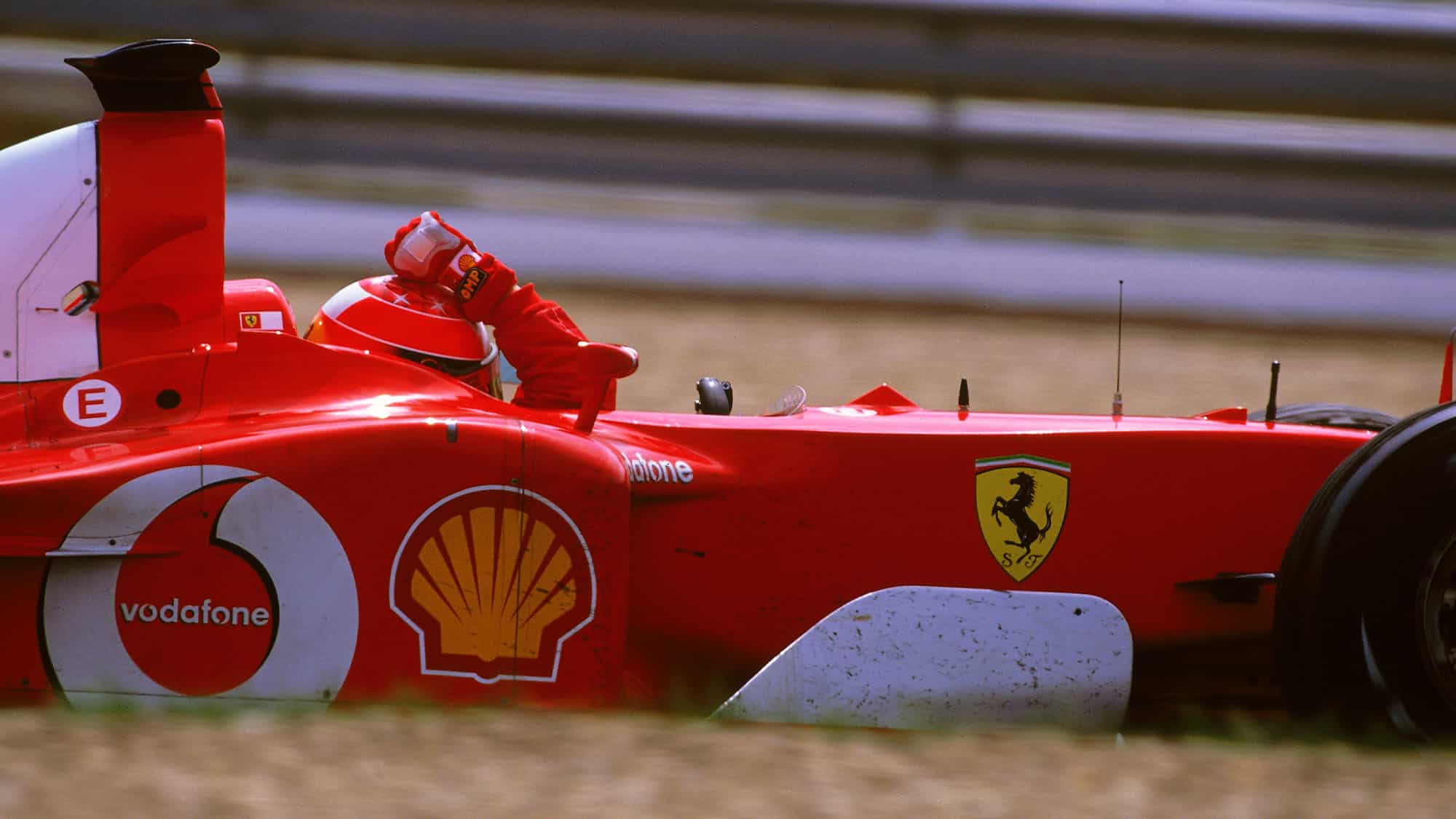 MAGNY-COURS - 21 JULY: Ferrari driver Michael Schumacher celebrates victory in the Formula One French Grand Prix at Magny-Cours in Nevers, France on July 21, 2002. Schumacher won the driver's championship to equal Fangio's record of 5 world titles. (photo by Bryn Lennon/Getty Images)