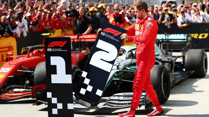 Sebastian Vettel moves the position boards after the 2019 Canadian Grand Prix