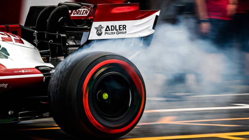 Smoke comes off the spinning soft F1 tyre of an Alfa Romeo