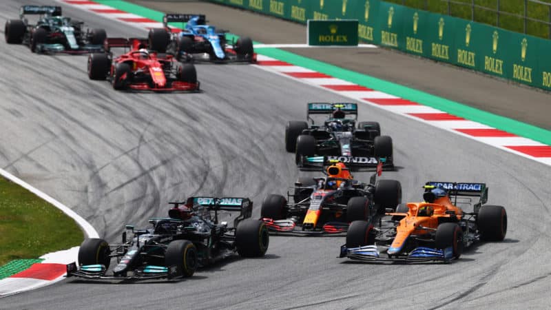 SPIELBERG, AUSTRIA - JUNE 27: Lewis Hamilton of Great Britain driving the (44) Mercedes AMG Petronas F1 Team Mercedes W12 leads Lando Norris of Great Britain driving the (4) McLaren F1 Team MCL35M Mercedes during the F1 Grand Prix of Styria at Red Bull Ring on June 27, 2021 in Spielberg, Austria. (Photo by Clive Rose/Getty Images)