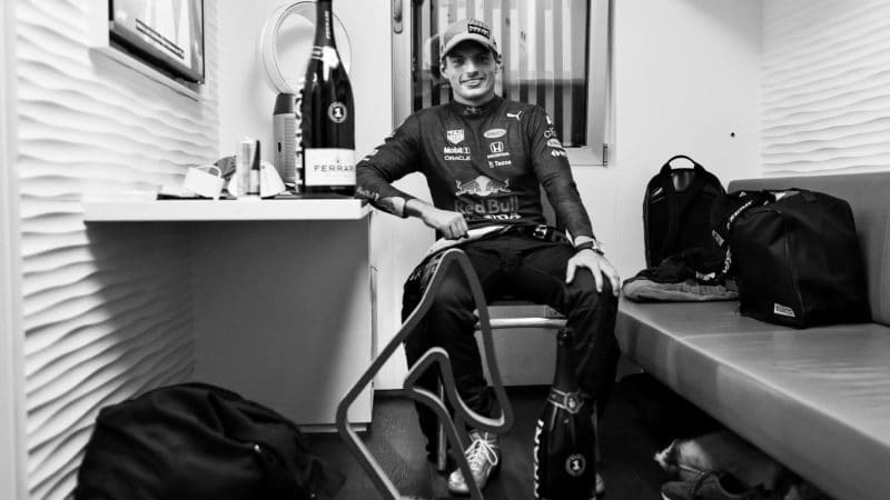 SPIELBERG, AUSTRIA - JUNE 27: (EDITORS NOTE: Image has been converted to black and white.) Race winner Max Verstappen of Netherlands and Red Bull Racing relaxes with his trophy and sparkling wine after the F1 Grand Prix of Styria at Red Bull Ring on June 27, 2021 in Spielberg, Austria. (Photo by Mark Thompson/Getty Images)