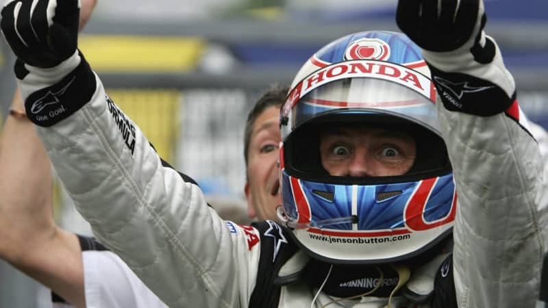 BUDAPEST, HUNGARY - AUGUST 06: Jenson Button of Great Britain and Honda Racing celebrates his first ever Formula One victory after winning the Hungarian Formula One Grand Prix at the Hungaroring on August 6, 2006 in Budapest, Hunagary. (Photo by Paul Gilham/Getty Images)