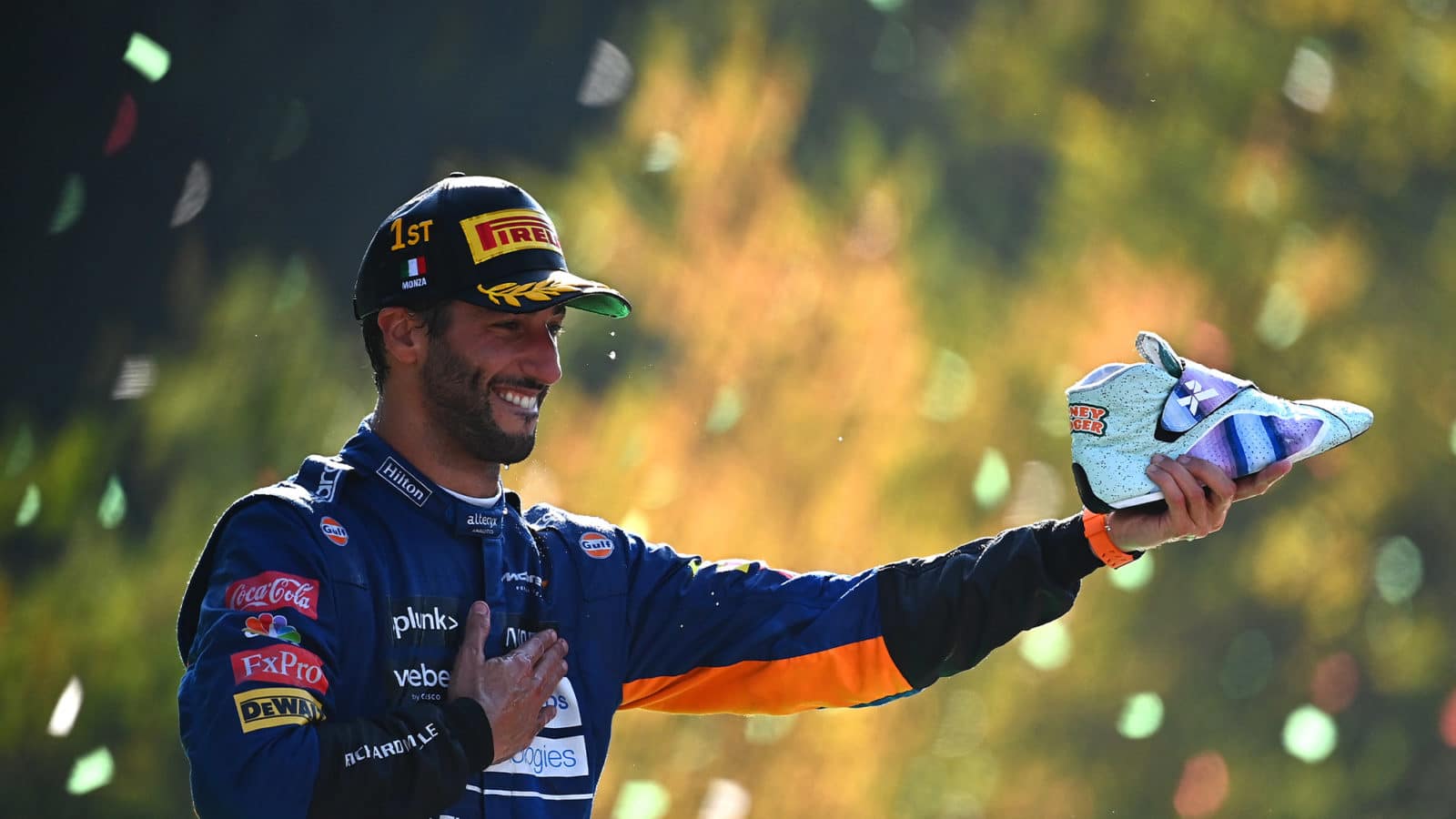 Daniel Ricciardo holds out his shoe after winning the 2021 Italian Grand Prix at Monza