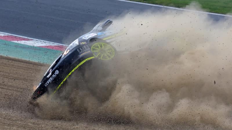 Honda Civic of Ben Sharpe rolls in the gravel at Brands Hatch
