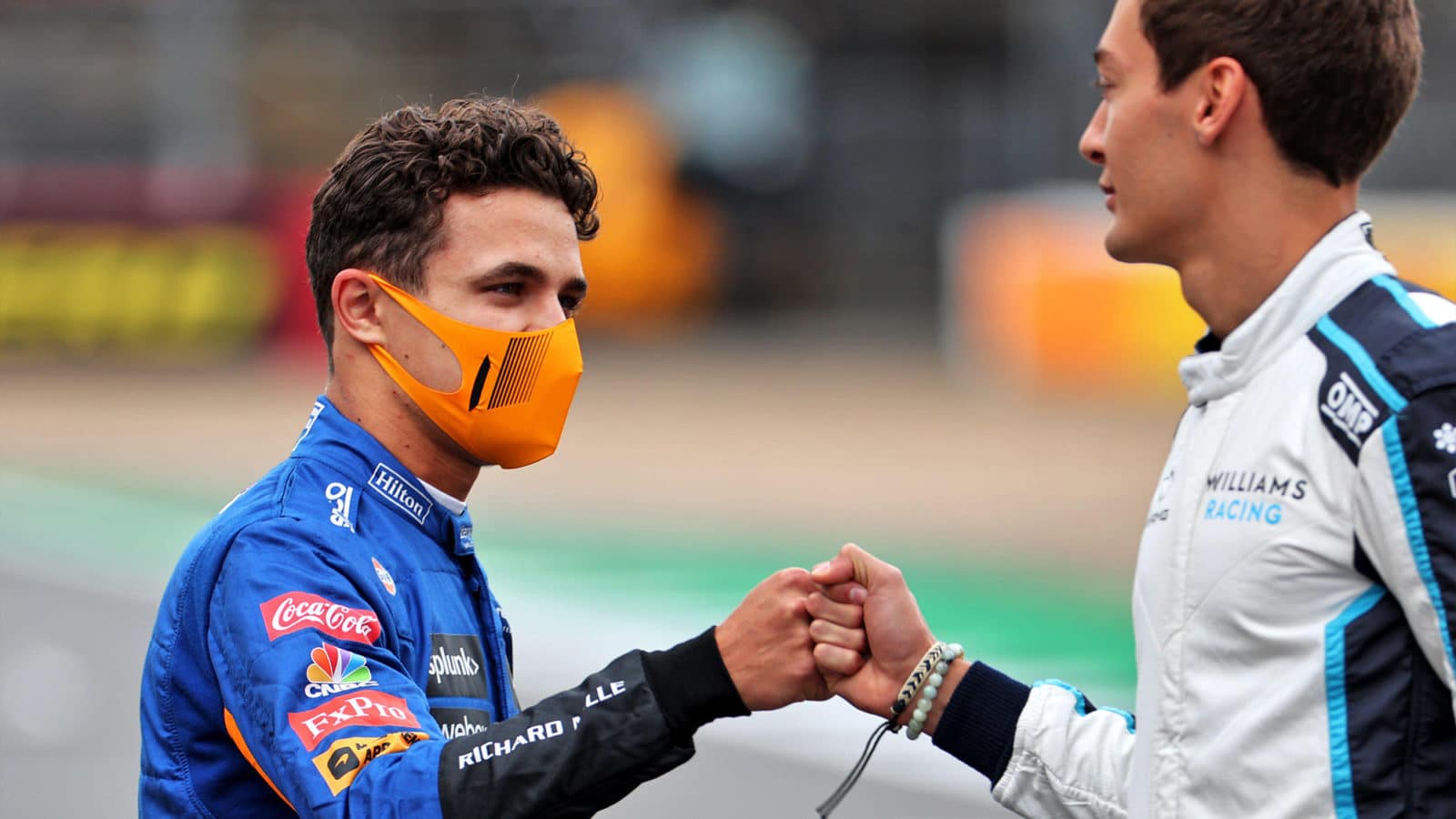 Lando Norris and George Russell bump fists at Silverstone 2021