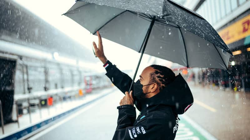 Lewis Hamilton waves to the crowd in wet Sochi