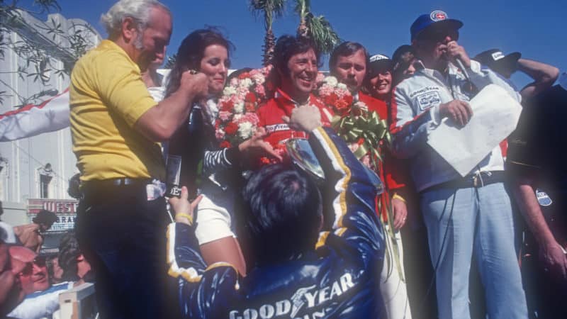 Mario Andretti on the podium at the 1977 Long Beach Grand Prix