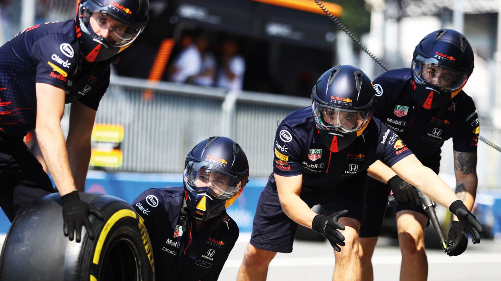 Red Bull mechanics wait for a pitstop