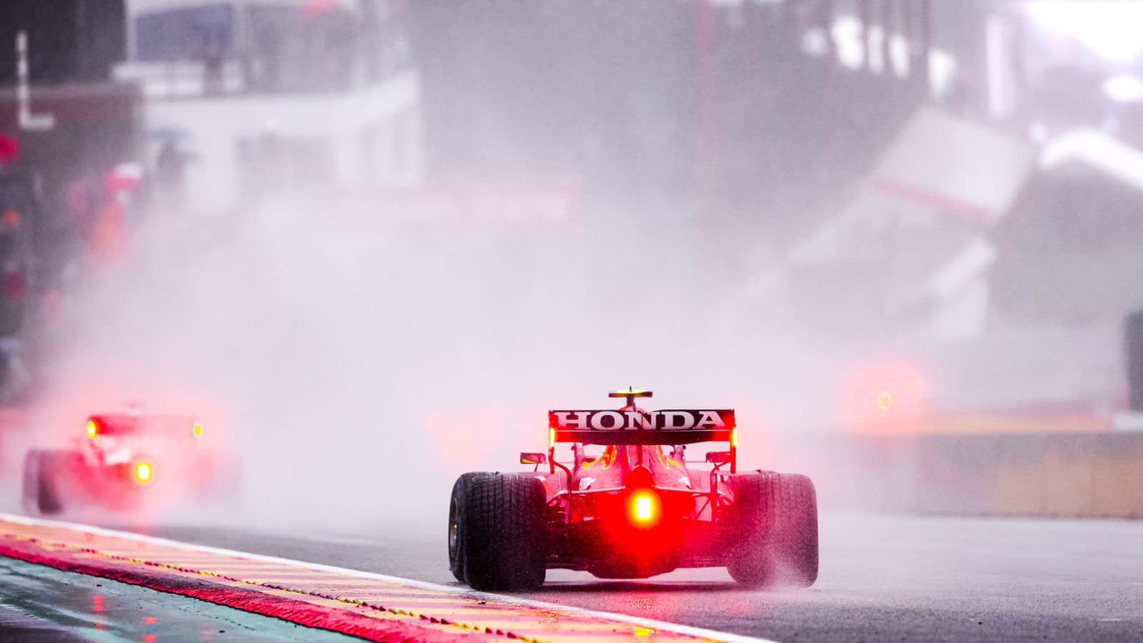 Red lights of F1 cars through the spray at the 2021 Belgian Grand Prix