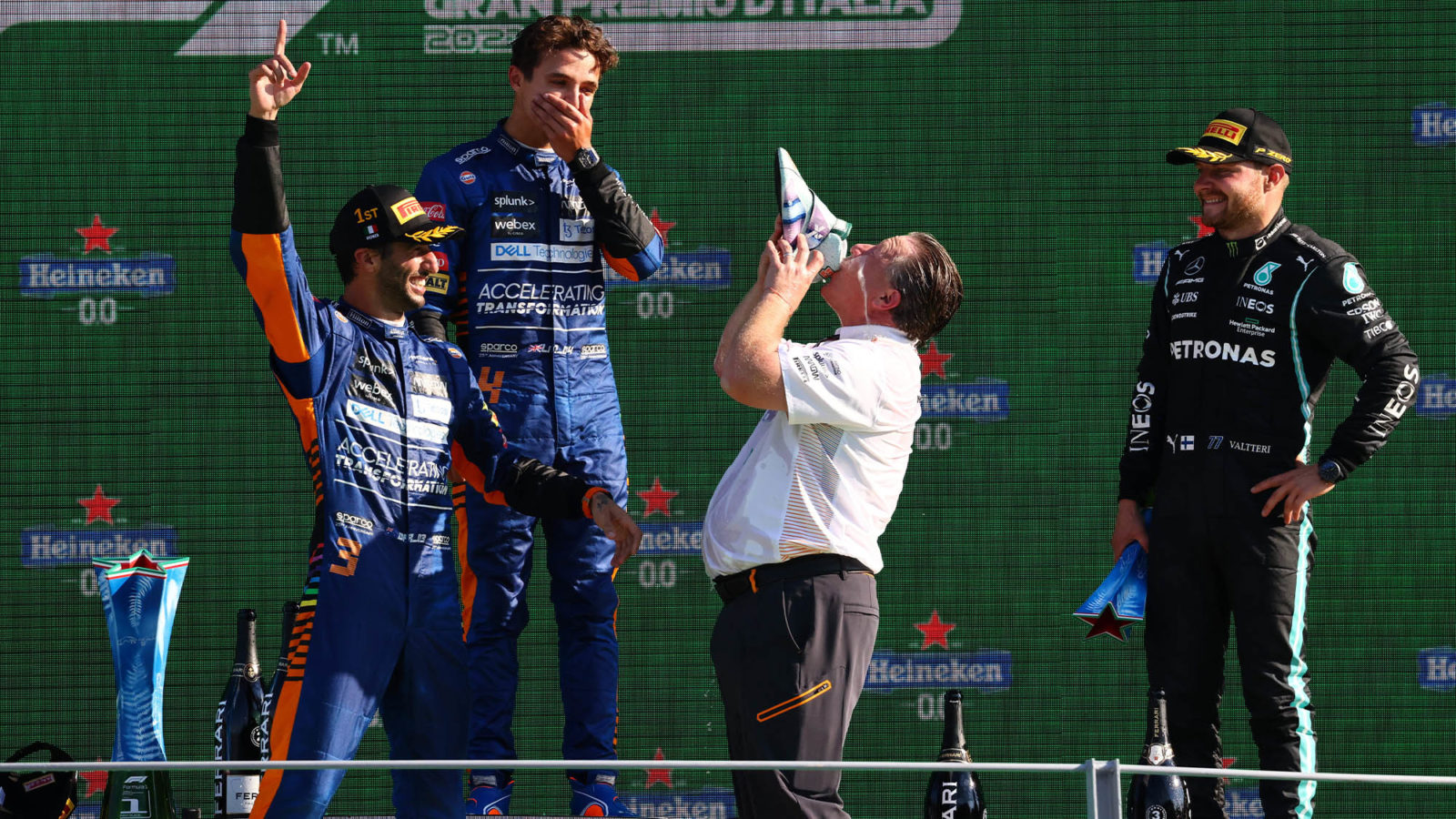 Zak Brown drinks from Daniel Ricciardo's shoe on the Monza podium