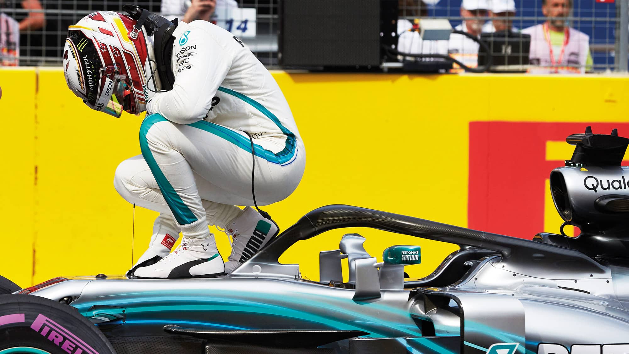 Lewis Hamilton crouches on his car after the 2018 French Grand Prix