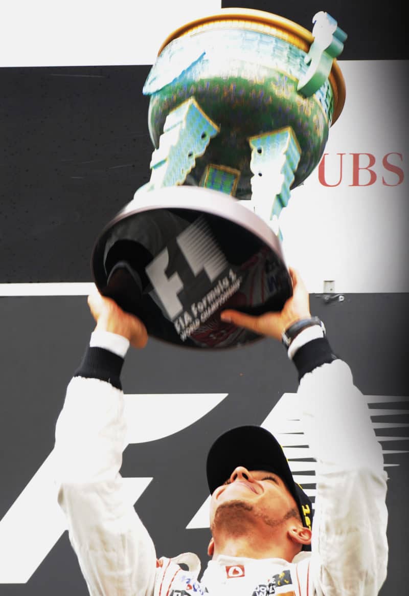 Lewis Hamilton lifts 2011 Chinese GP trophy