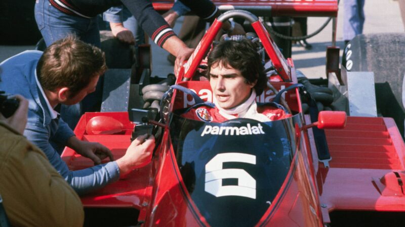 Race car driver Nelson Piquet speaks from inside his Brabham-Alpha Romeo racecar. (Photo by © Hulton-Deutsch Collection/CORBIS/Corbis via Getty Images)