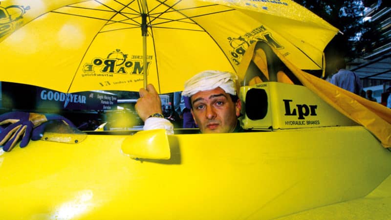 Gabriele Tarquini under a yellow umbrella at 1988 Monaco Grand Prix