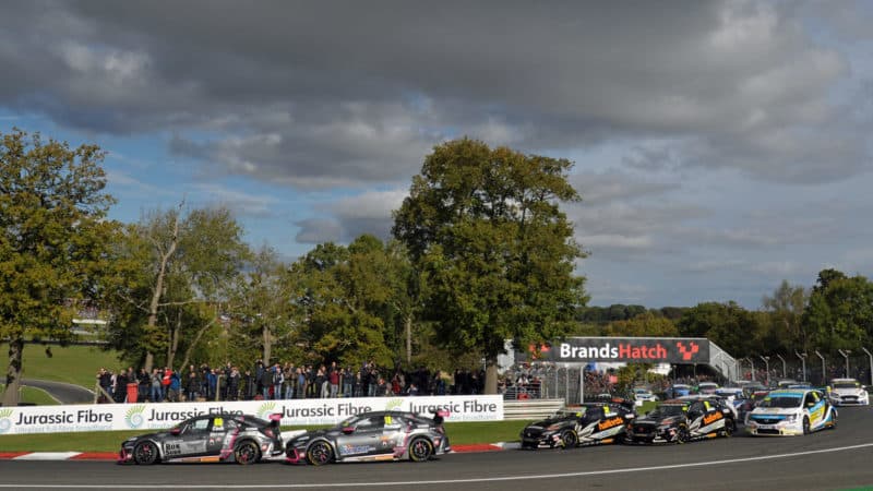 Josh Cook leads around Druids at the start of BTCC opening race at Brands Hatch