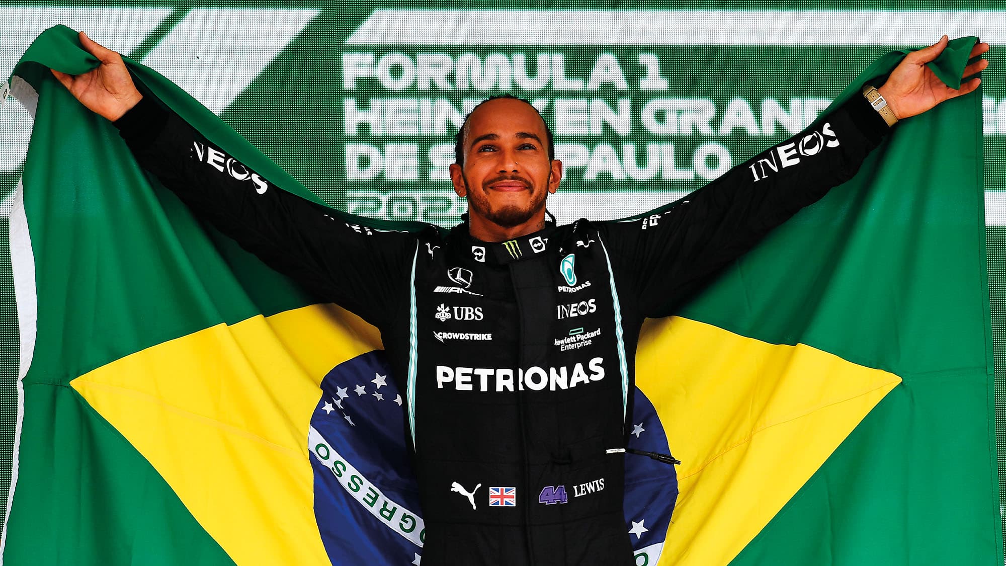 Lewis Hamilton with flag of Brazil after winning the grand prix at Interlagos