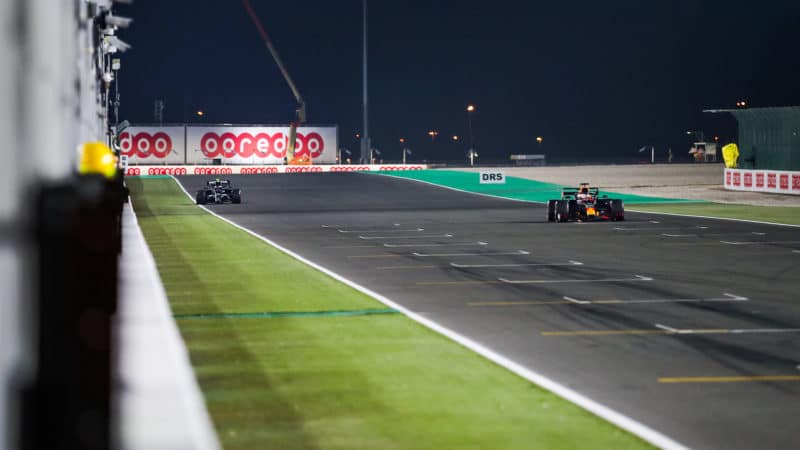 Max Verstappen crosses the line at Qatar past stopped Pierre Gasly