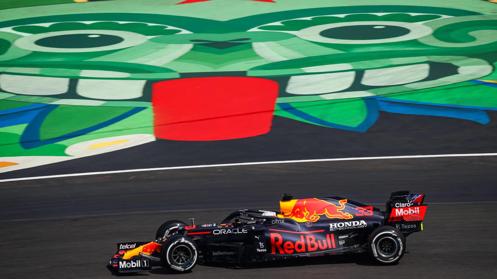 Max Verstappen races past face paionted on track at the 2021 Mexican Grand Prix