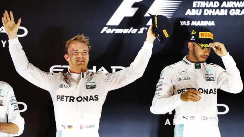 Nico Rosberg celebrates winning his 2016 F1 championship while Lewis Hamilton looks away