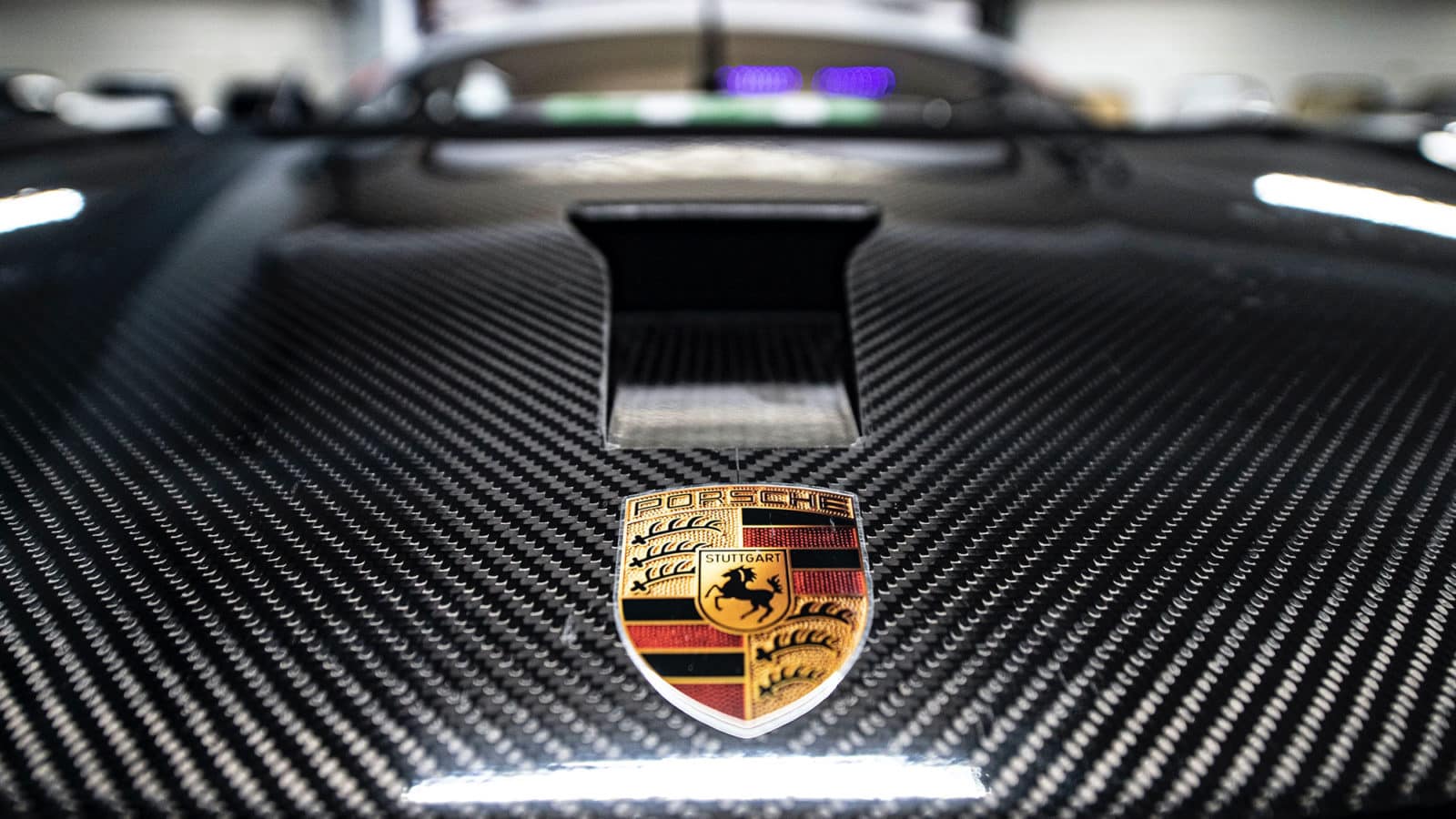 Porsche-badge-on-carbon-fibre