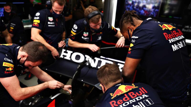 Red Bull mechanics working on rear wing of Sergio Perez