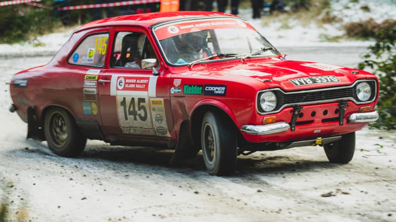 Red Ford Escort sliding in the snow during roger Albert Clark Rally